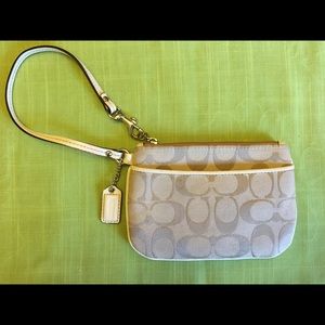 COACH wristlet cream colored and tan.